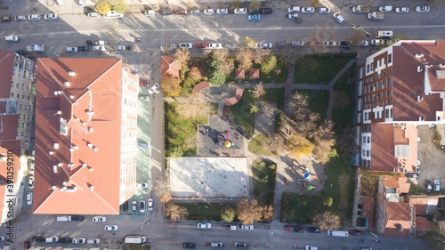 aerial view of street basketball court and children playground. kids are playing football at the sunset.
