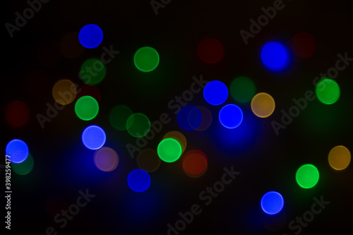 Abstract background, multicolored bokeh on a black background.