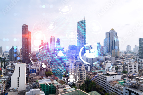 Social media icons hologram over panorama city view of Bangkok, Asia. The concept of people networking and connections. Double exposure.