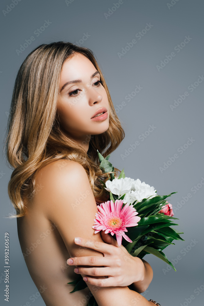 charming, topless woman posing with flowers isolated on grey charming, topless woman posing with flowers isolated on grey