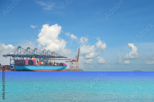 Container ship Mooring in port, Logistics import export background of container Cargo ship in seaport on blue sky, fright Transportation.