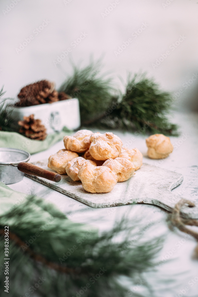Profiteroles with custard on the table. New Year's dessert Profiteroles with custard on the table. New Year's dessert
