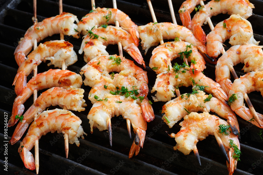 Grilled king prawns on wooden skewers. Grilled king prawns on wooden skewers.