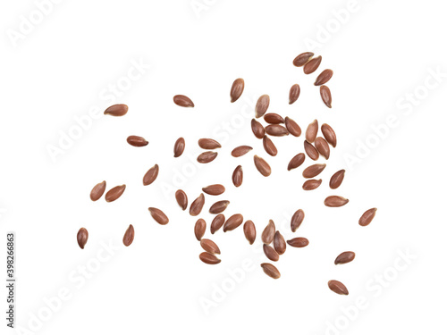 Close up of spread out linseed or flax seed seen directly from above and isolated on white with shadows
