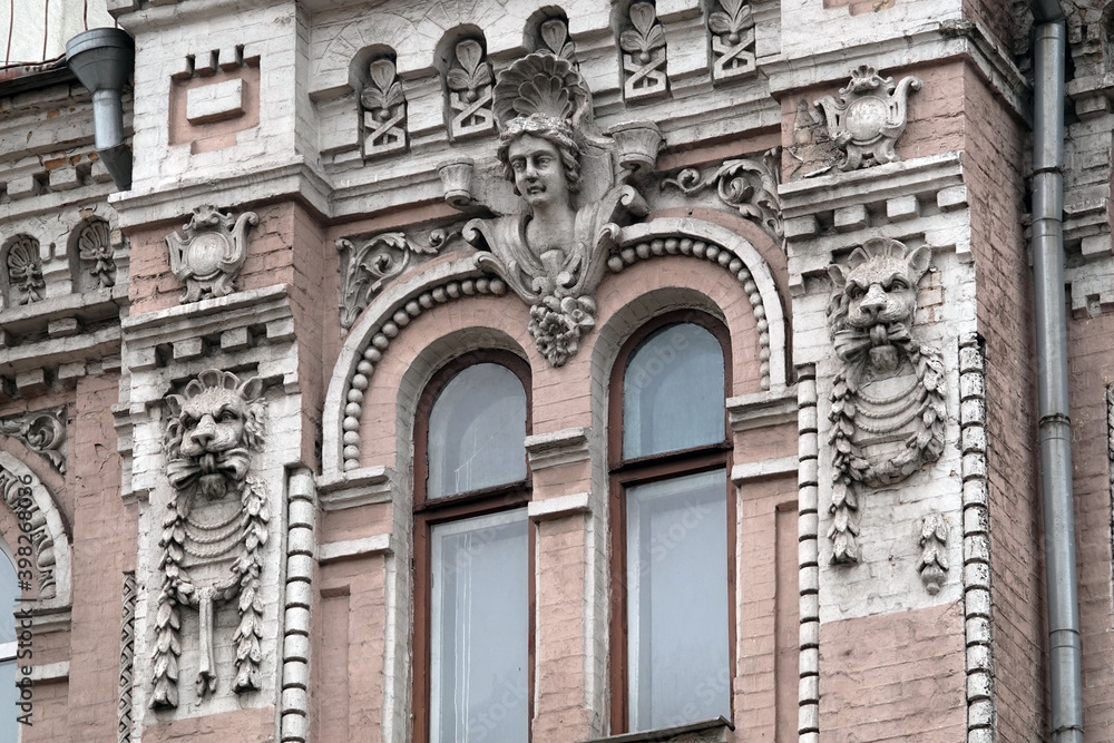 Fototapeta premium Building facade decor with human face