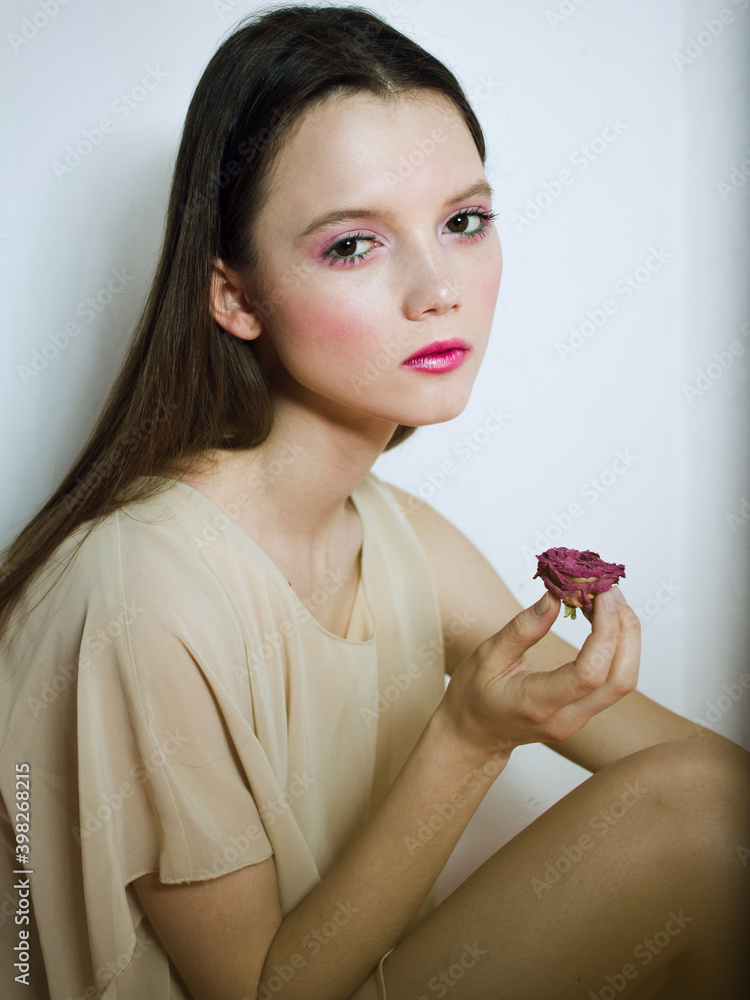 portrait of a young woman with flower. Pink lipstick. Long hair portrait of a young woman with flower. Pink lipstick. Long hair