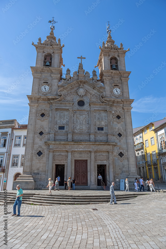 Main facade of Holy Cross Church, early baroque facade, front piazza and tourist people outside