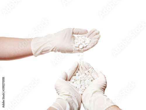 hands in sterile white gloves pour tablets from hand to hand, a concept on theme of drug addiction isolated on a white background mock up with copy space.