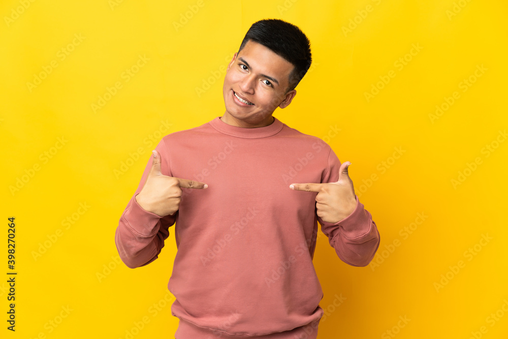 Young Ecuadorian man isolated on yellow background proud and self-satisfied Young Ecuadorian man isolated on yellow background proud and self-satisfied