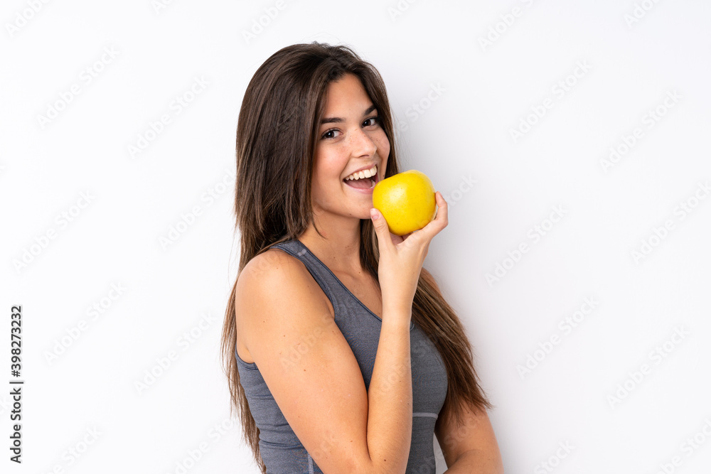 Teenager Brazilian girl with an apple over isolated background Teenager Brazilian girl with an apple over isolated background