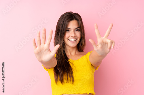 Teenager Brazilian girl over isolated pink background counting eight with fingers
