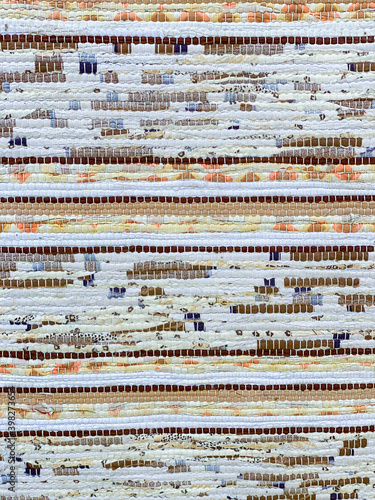 Rag rug close up. Reused fabric. Brown, yellow, white, blue and orange.