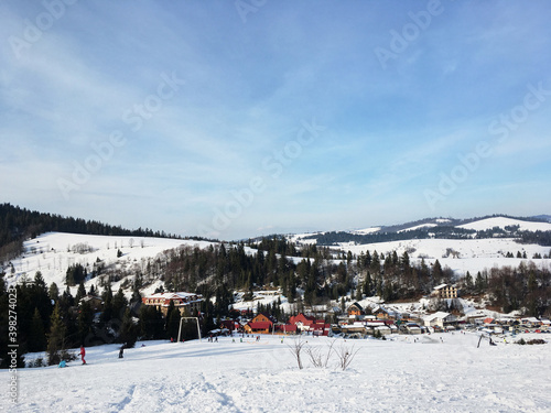 Beautiful natural landscape with mountains covered with snow. Landscape picture of ski resort from top at sunny weather. Active recreation in the mountains. Isolation concept during quarantine.