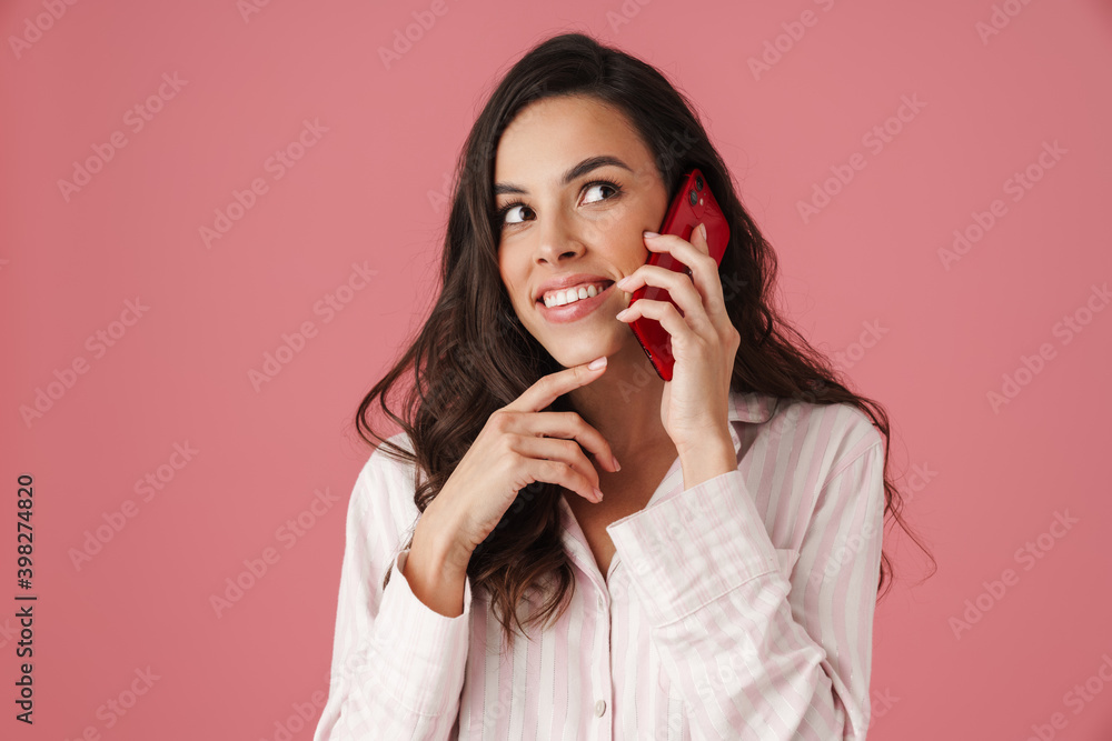Cheerful beautiful woman smiling while talking on mobile phone Cheerful beautiful woman smiling while talking on mobile phone