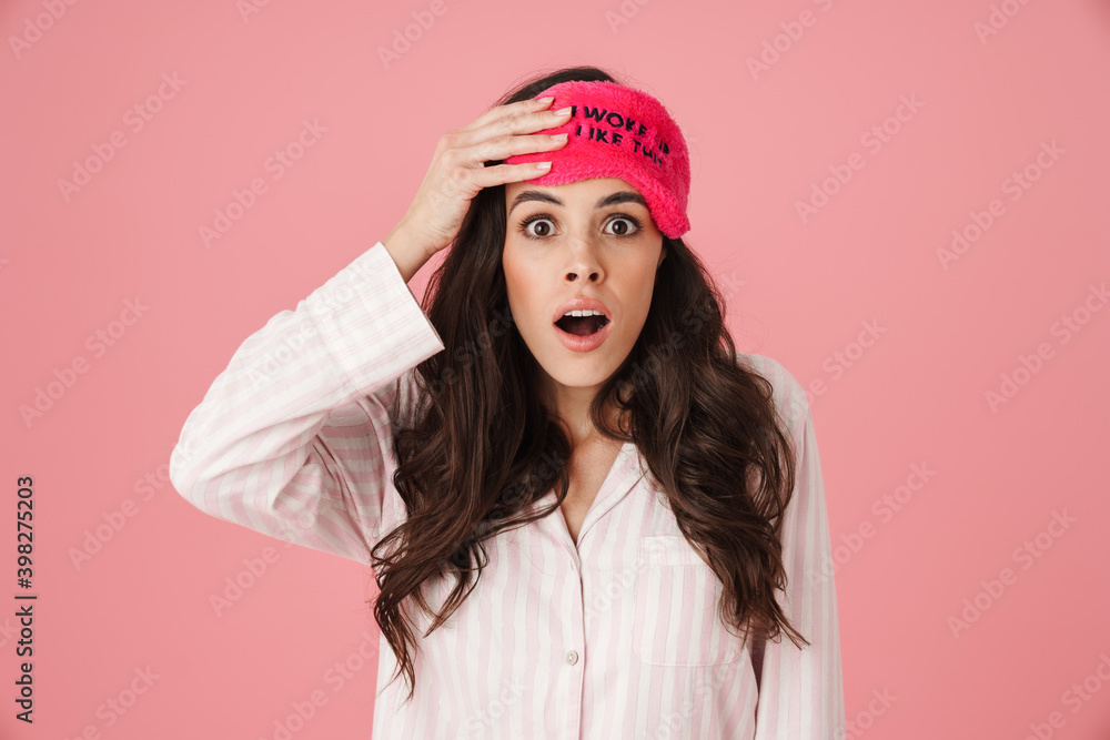 Shocked beautiful woman posing in sleeping mask and pajama Shocked beautiful woman posing in sleeping mask and pajama