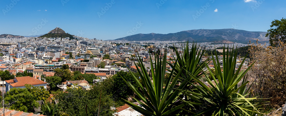 wide panorama of the city on a sunny day. The hills, mountains and dense buildings of the city of athens.