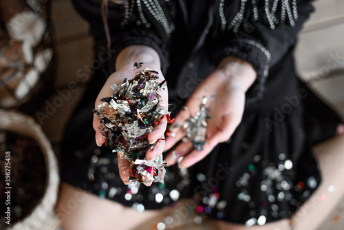girl and colorful confetti in hands
