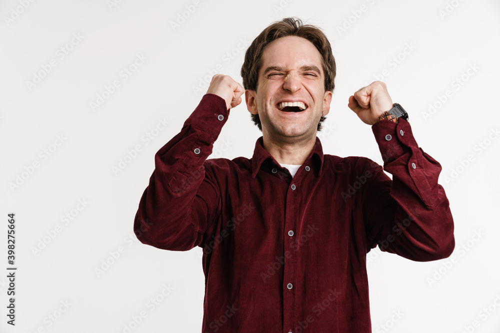 Fototapeta premium Handsome excited guy exclaiming and making winner gesture