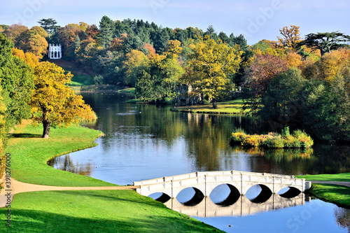Autumn View of the 5 Arch Bridge and the Gothic Temple in Painshill Park at Cobham, Surrey.