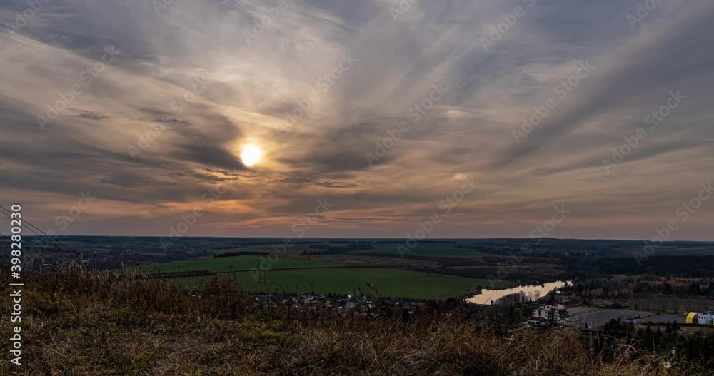 Beautiful evening sunset, time lapse, movement of clouds of a different level against the setting sun Beautiful evening sunset, time lapse, movement of clouds of a different level against the setting sun