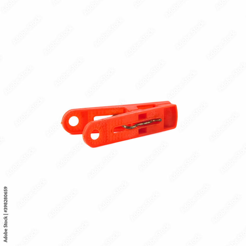 Red plastic clothespin isolated on a white background