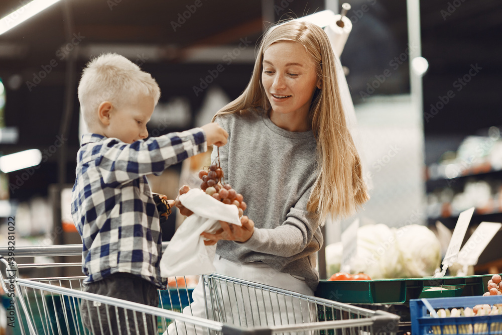 Family buying groceries. Mother in gray sweater.
