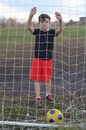 Young football player near the football doal.