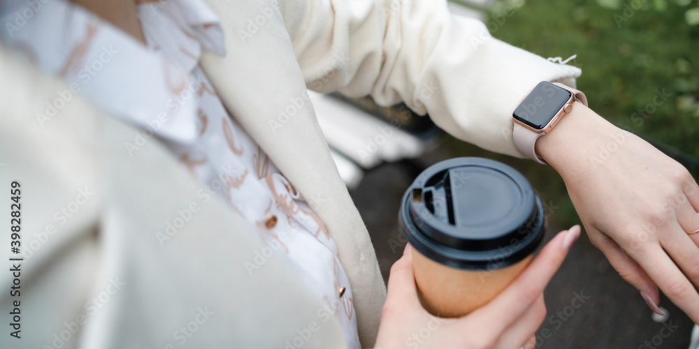 Smart watch and coffee in the hands of a girl Smart watch and coffee in the hands of a girl