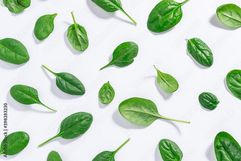 Seamless pattern made with green juicy baby spinach leaves on white background. Healthy food concept. Spinach wallpaper. Seamless pattern made with green juicy baby spinach leaves on white background. Healthy food concept. Spinach wallpaper.