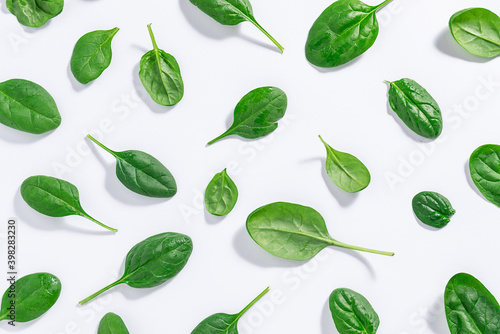 Seamless pattern made with green juicy baby spinach leaves on white background. Healthy food concept. Spinach wallpaper.
