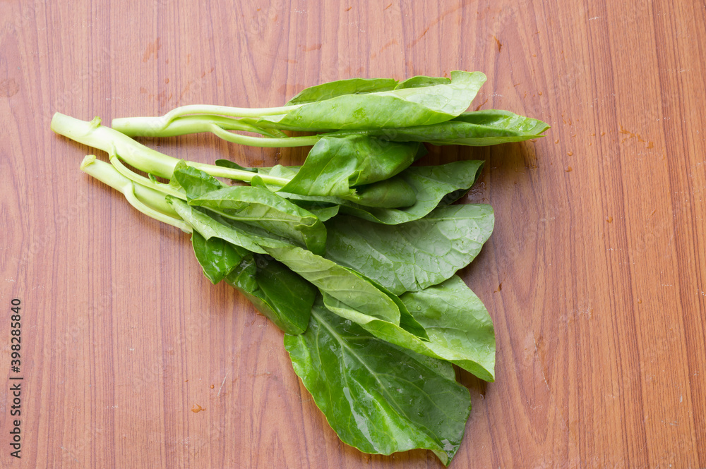 fresh spinach on wooden table fresh spinach on wooden table