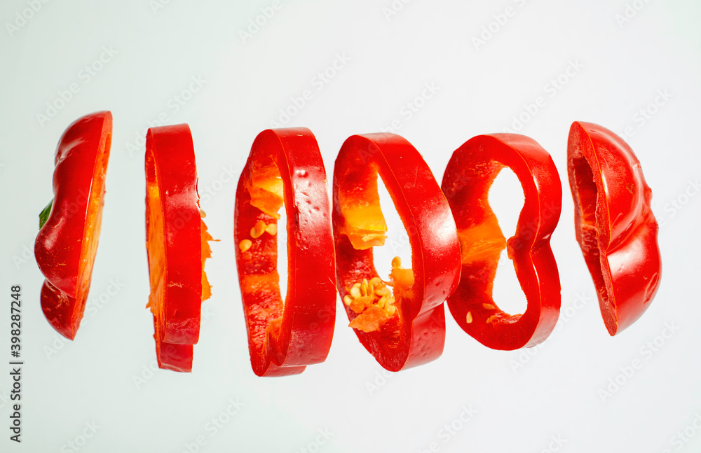 Red bell pepper slices floating isolated on white background Red bell pepper slices floating isolated on white background