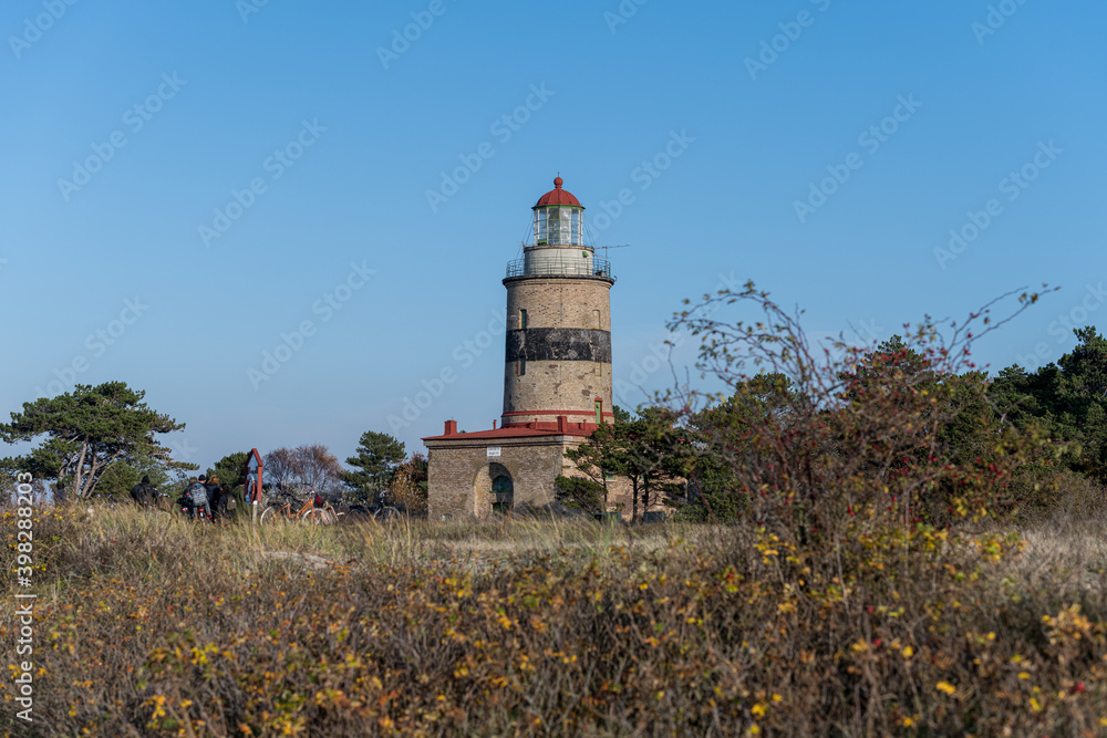 A brick lighthouse with a bright blue sky in the background. Picture of Falsterbo Lighthouse built in 1796, Scania, Sweden