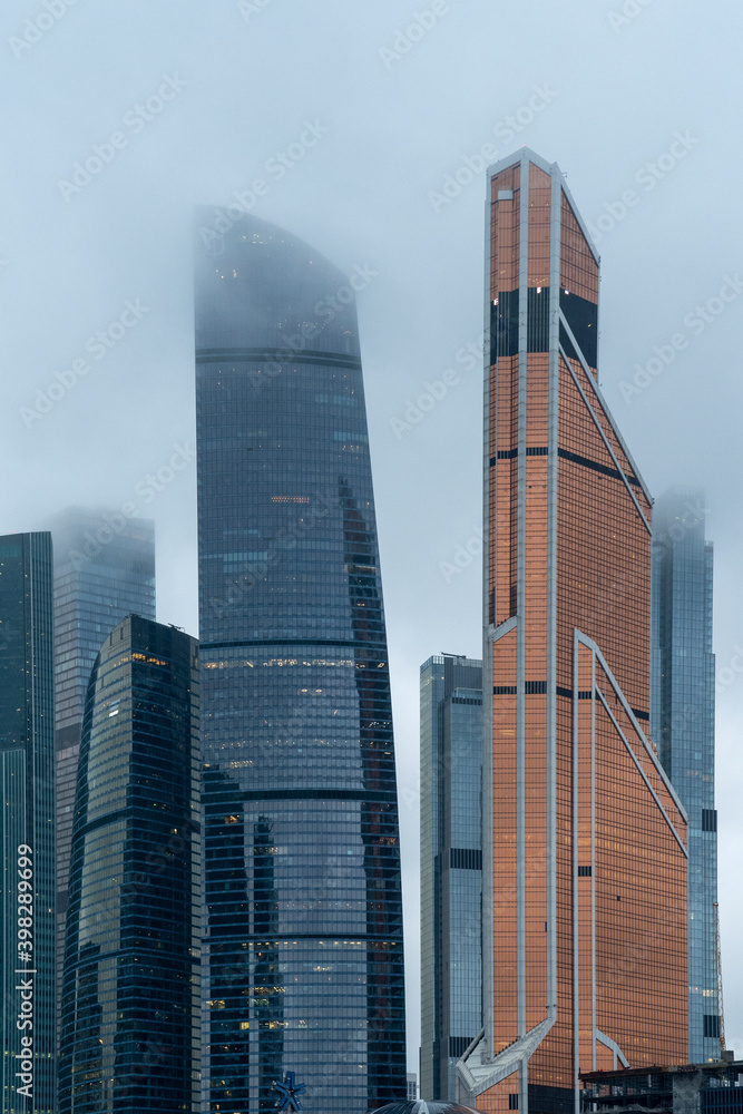 Fototapeta premium Moscow, Russia, November 30, 2020, Moscow international business center (Moscow city), night photography with long exposure, selective focusing, glare of night lights, foggy rainy weather