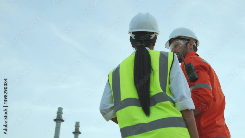 successful engineer teamwork concept caucasian male supervisor manager and asian female engineer working with safety helmet discussion consult with oil refinery industry plant background successful engineer teamwork concept caucasian male supervisor manager and asian female engineer working with safety helmet discussion consult with oil refinery industry plant background