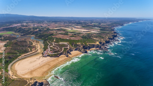  Aerial panorama of the village and Odeceixe beach, in summer overlooking the Algarve. Portugal  photo