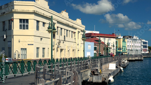 Fotografi Famous Boardwalk with distant walking tourists and locals  on a nice sunny afternoon in Bridgetown, Barbados