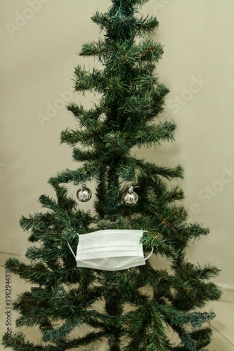 Christmas tree with face mask. Christmas decoration. Coronavirus pandemic Covit-19.
