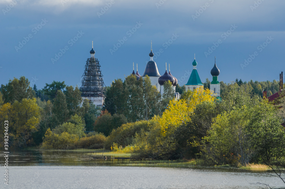 Siya. Autumn view of the Anthony-Siyskiy monastery. Temples among the autumn forest. Russia, Arkhangelsk region