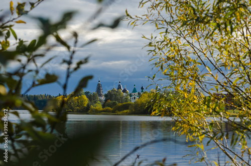 Siya. Autumn view of the Anthony-Siyskiy monastery. Temples among the autumn forest. Russia, Arkhangelsk region photo