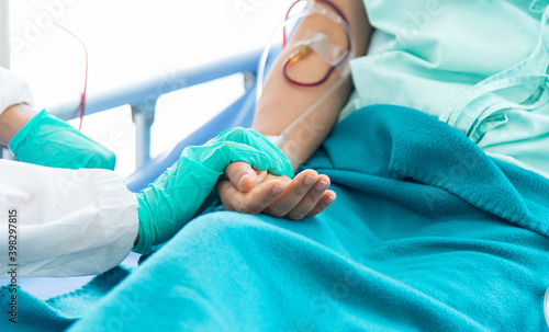 Doctor checking pulse and heart rate on patient wrist in the hospital.