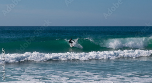 Young surfer riding perfect surf wave at the beach of El Palmar. Spanish Atlantic coast in Cadiz, perfect surfing spot in Europe © Pablo