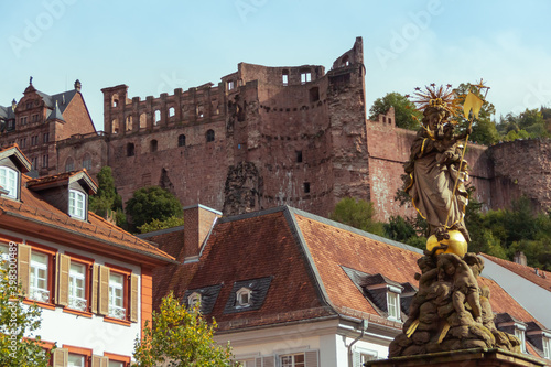 religious figure in surrounded by houses and ruins in a city of germany