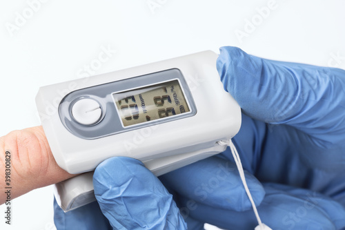 Pulse oximeter shows normal blood oxygen saturation level during checking coronavirus symptoms