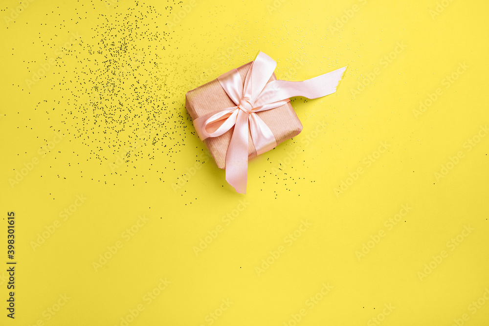 New Year's gift and yellow background with Illuminating sequins New Year's gift and yellow background with Illuminating sequins