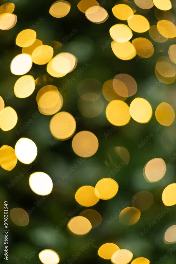 Blurred photo of yellow bokeh background of defocused glittering lights