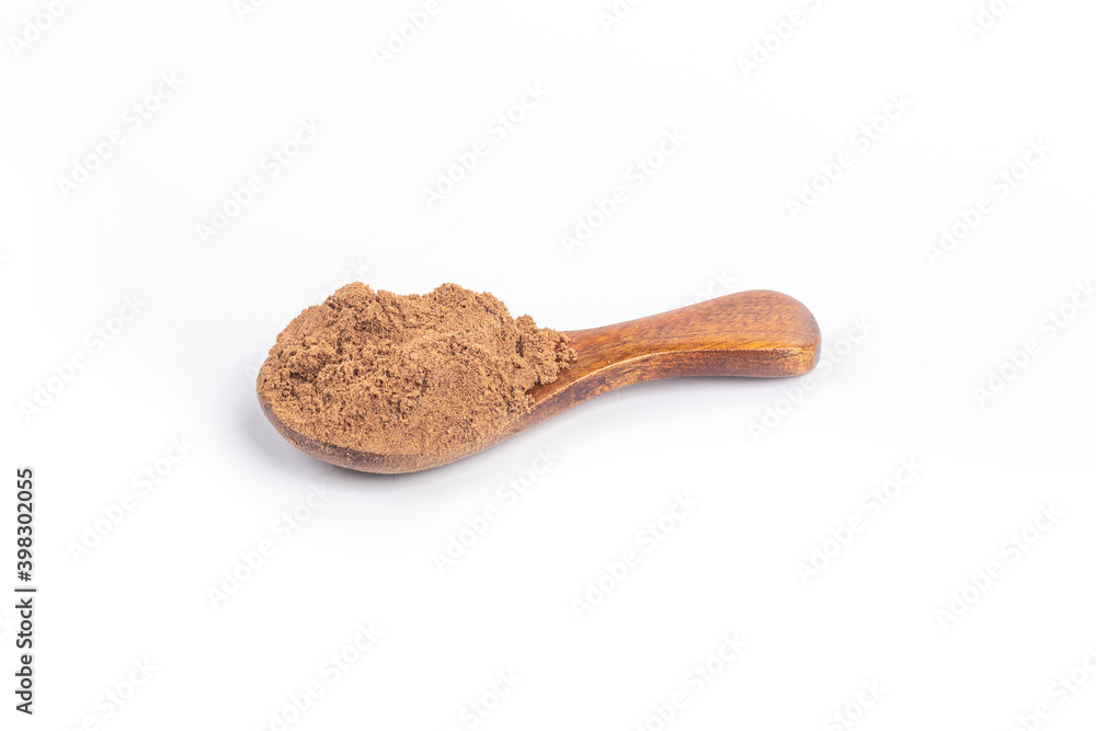 Studio lighting. allspice on a wooden spoon, on a white background. There is a shadow. Close-up. No isolation. Studio lighting. allspice on a wooden spoon, on a white background. There is a shadow. Close-up. No isolation.