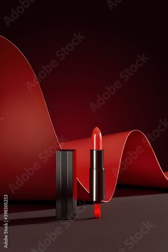 Lipstick. Creative concept of red lipstick on black photo