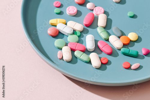 Vitamin pills served in plate photo