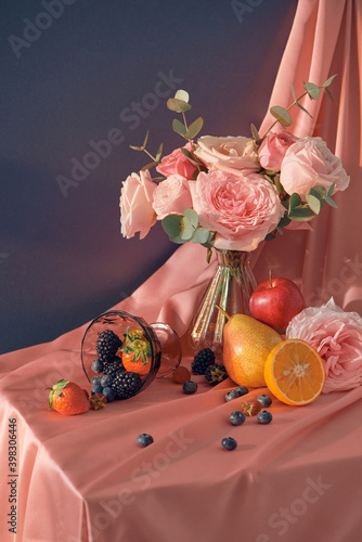 Sunny still life with garden flowers and fruits. bouquet in a vase